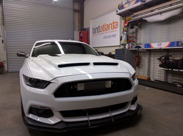 Ford Mustang GT front view showing professional dark window tint by Tint Atlanta