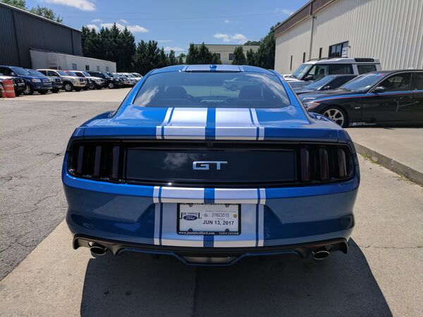 Blue Ford Mustang GT with racing stripes and tinted windows Woodstock